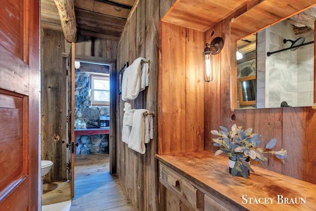 2620 36th St, Allegan, MI 49010 - bathroom with wooden walls, toilet, wooden ceiling, and wood-type flooring