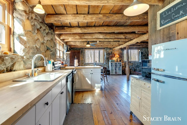 2620 36th St, Allegan, MI 49010 - kitchen with white cabinetry, a sink, wood ceiling, beam ceiling, and freestanding refrigerator