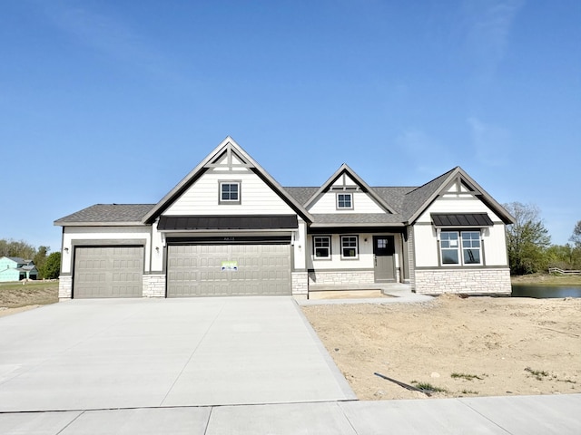 craftsman-style home featuring stone siding, an attached garage, driveway, covered porch, and roof with shingles