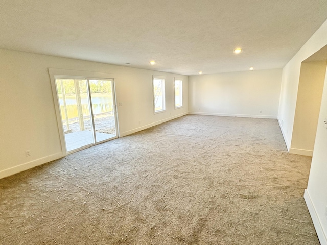 carpeted spare room with baseboards and recessed lighting