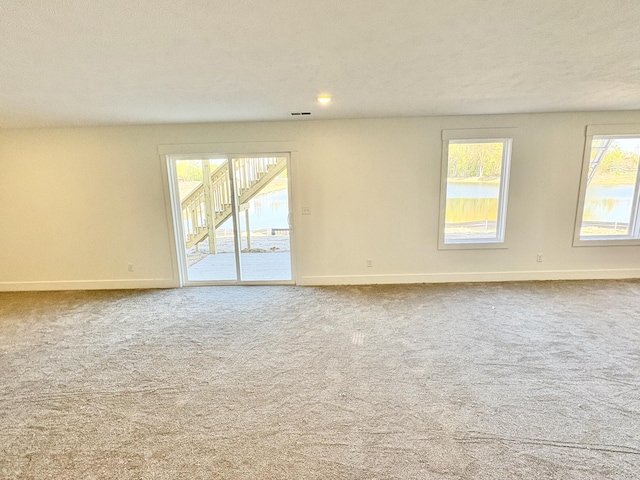 carpeted empty room with baseboards