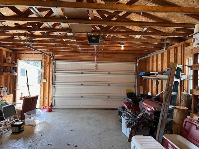 8034 N Johnson Rd, Irons, MI 49644 - garage featuring a garage door opener