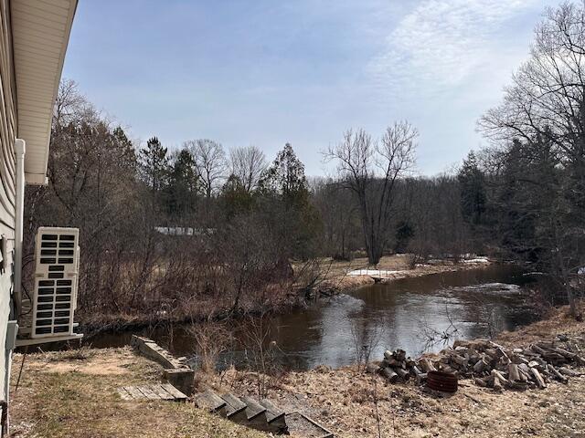 8034 N Johnson Rd, Irons, MI 49644 - property view of water with a forest view and stairway