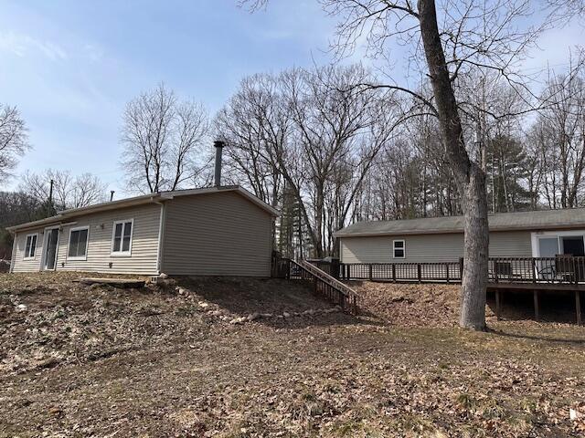 8034 N Johnson Rd, Irons, MI 49644 - view of property exterior with a wooden deck