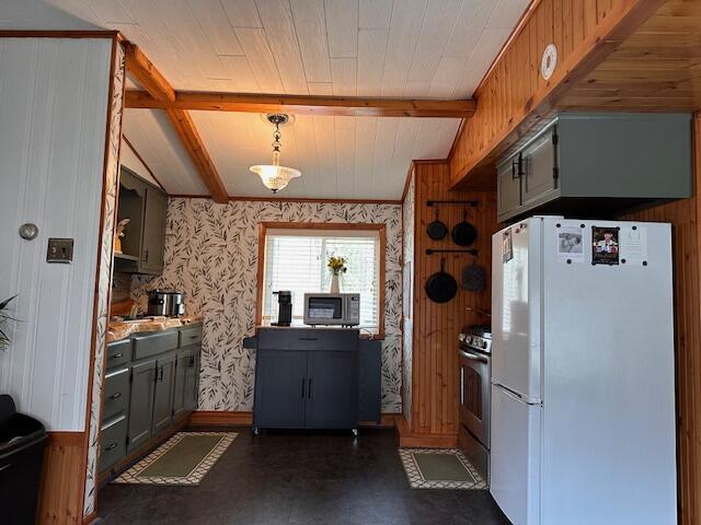 8034 N Johnson Rd, Irons, MI 49644 - kitchen with wallpapered walls, appliances with stainless steel finishes, baseboards, beamed ceiling, and decorative light fixtures