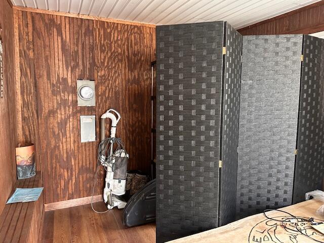 8034 N Johnson Rd, Irons, MI 49644 - unfurnished bedroom with wooden ceiling, wood walls, and wood finished floors