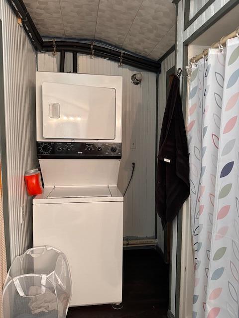 8034 N Johnson Rd, Irons, MI 49644 - clothes washing area featuring stacked washer / drying machine and laundry area
