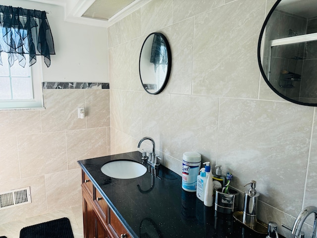 30347 Dell Ln, Warren, MI 48092 - bathroom featuring tile walls, vanity, a tile shower, and decorative backsplash