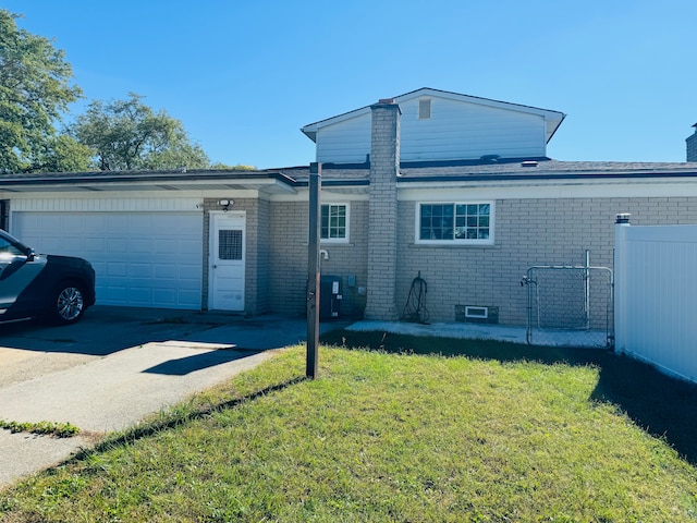 30347 Dell Ln, Warren, MI 48092 - view of front of home with a chimney, brick siding, an attached garage, and driveway