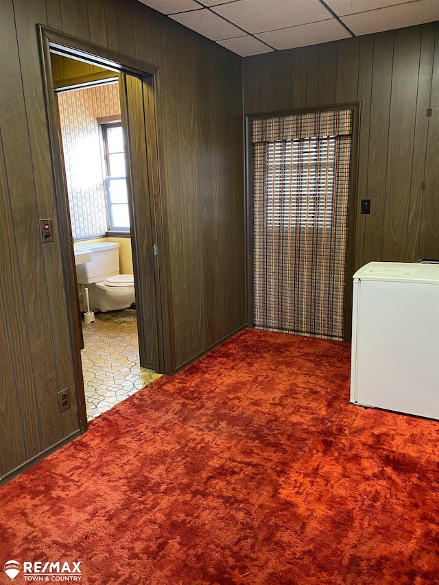 6007 Corunna Rd, Flint, MI 48532 - unfurnished room featuring washer / dryer, wood walls, and carpet flooring