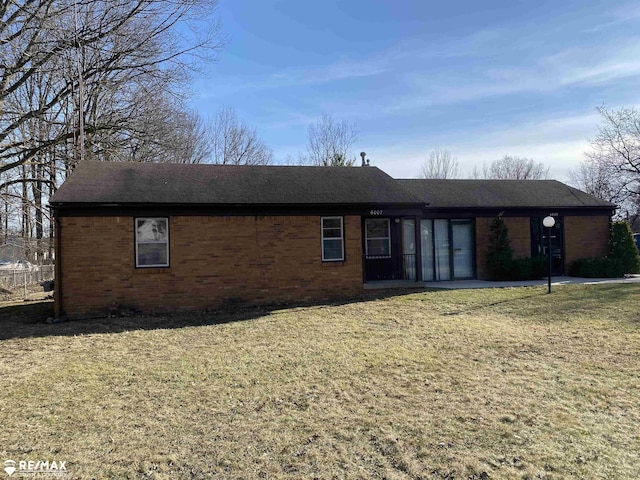 6007 Corunna Rd, Flint, MI 48532 - single story home featuring brick siding, roof with shingles, and a front lawn