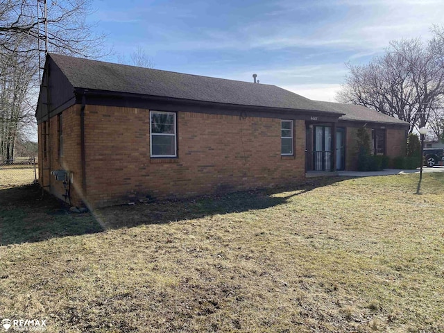 6007 Corunna Rd, Flint, MI 48532 - view of home's exterior with brick siding and a shingled roof