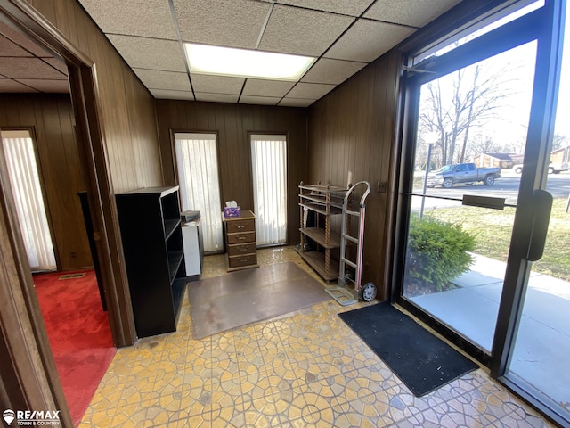 6007 Corunna Rd, Flint, MI 48532 - interior space featuring plenty of natural light, wood walls, a paneled ceiling, and light flooring