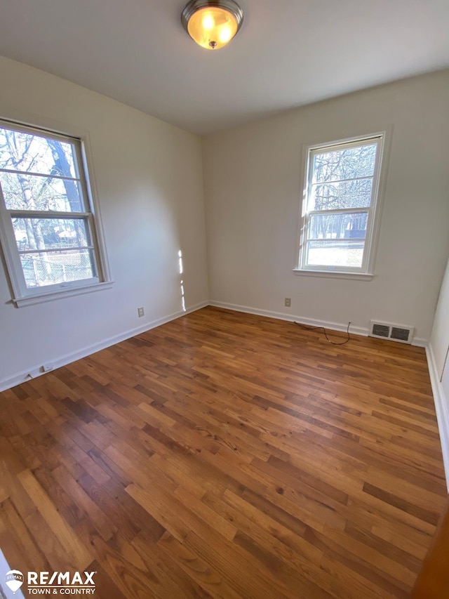 6007 Corunna Rd, Flint, MI 48532 - empty room with wood finished floors and baseboards