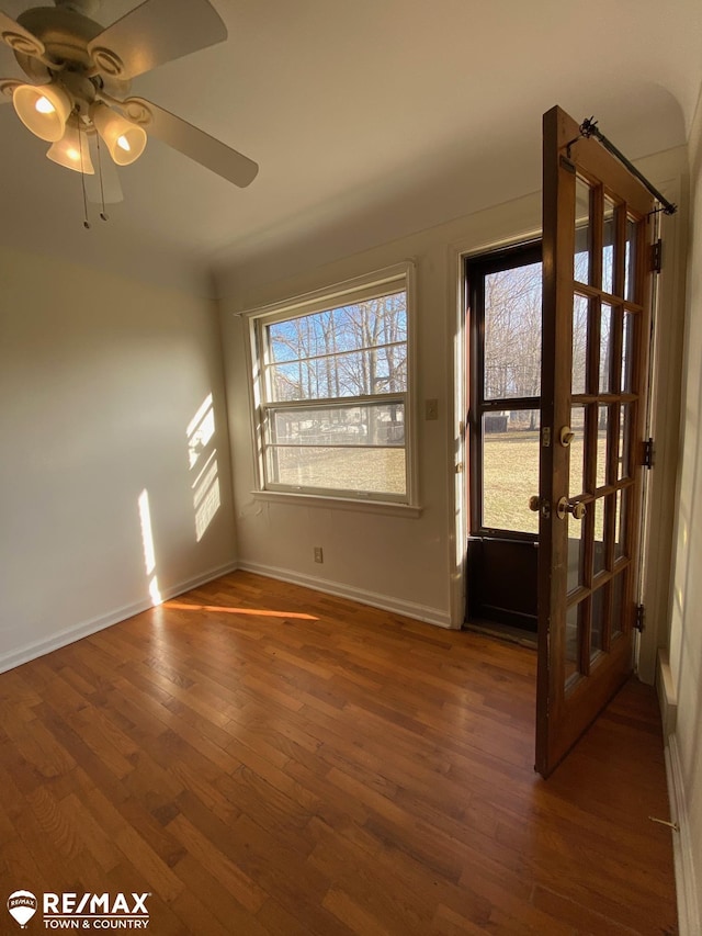 6007 Corunna Rd, Flint, MI 48532 - entryway with wood-type flooring, a ceiling fan, and baseboards