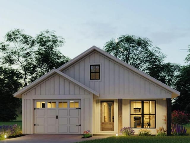 modern farmhouse style home with driveway, a garage, and board and batten siding