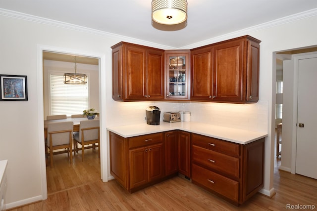 4121 S Fulton Pl, Royal Oak, MI 48073 - kitchen with light countertops, light wood-style floors, glass insert cabinets, decorative backsplash, and crown molding
