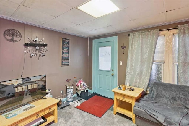 carpeted entryway with a paneled ceiling