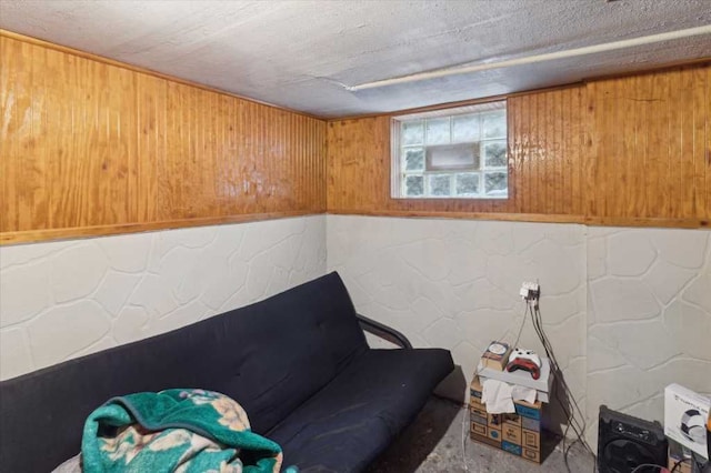 living area featuring concrete block wall