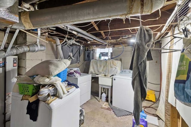 basement featuring washing machine and clothes dryer and electric panel