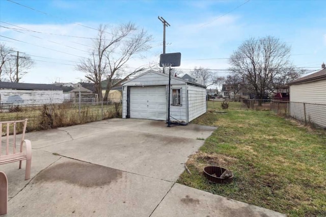 detached garage with fence and concrete driveway