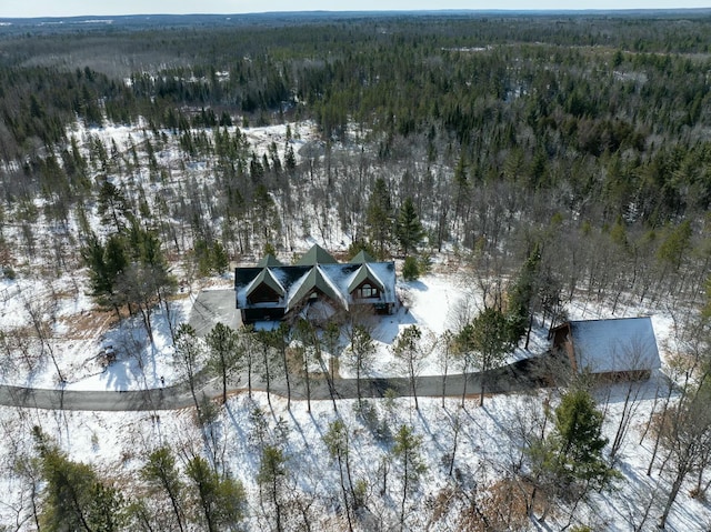 snowy aerial view featuring a view of trees
