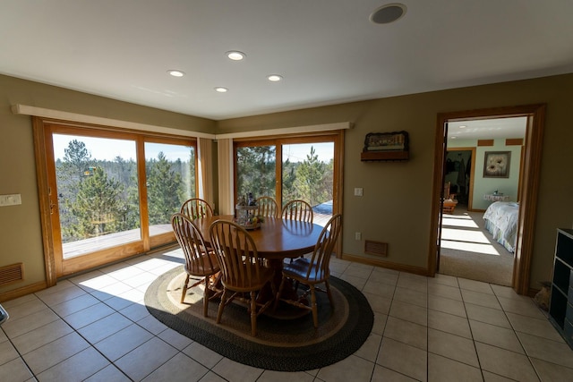 dining area with visible vents, light tile patterned floors, and plenty of natural light