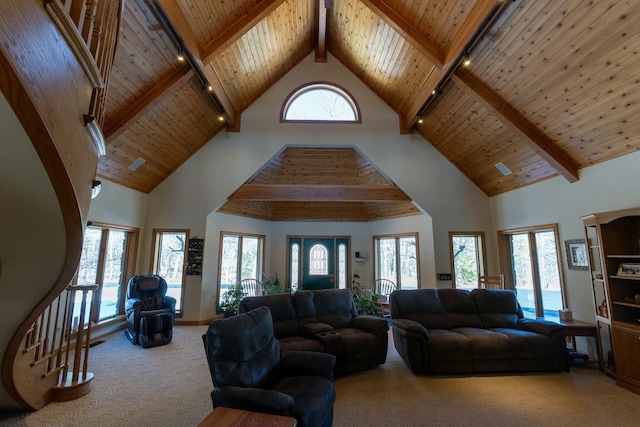 carpeted living area featuring beamed ceiling, wood ceiling, and a healthy amount of sunlight