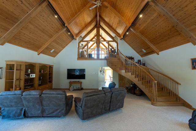 living area featuring stairway, carpet, wood ceiling, beamed ceiling, and ceiling fan