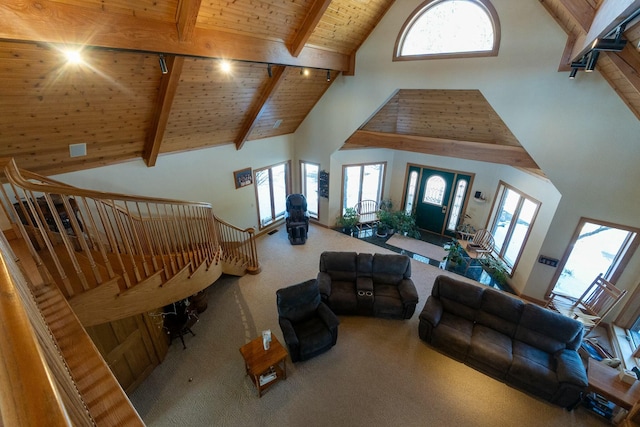 living room featuring beam ceiling, wooden ceiling, and carpet floors