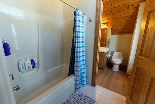 full bath with tile patterned floors, vanity, toilet, and shower / tub combo