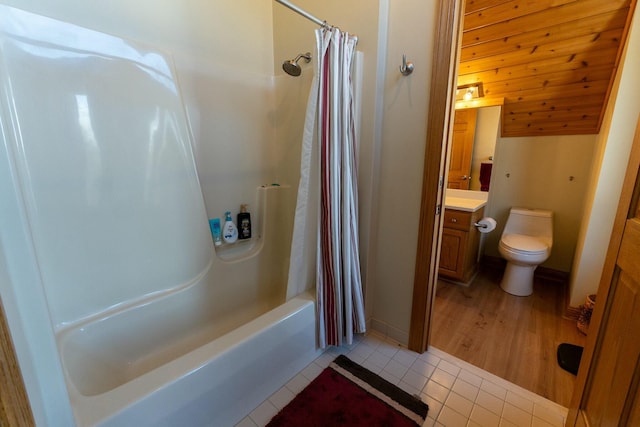 bathroom with vaulted ceiling, toilet, vanity, tile patterned flooring, and shower / bath combination with curtain