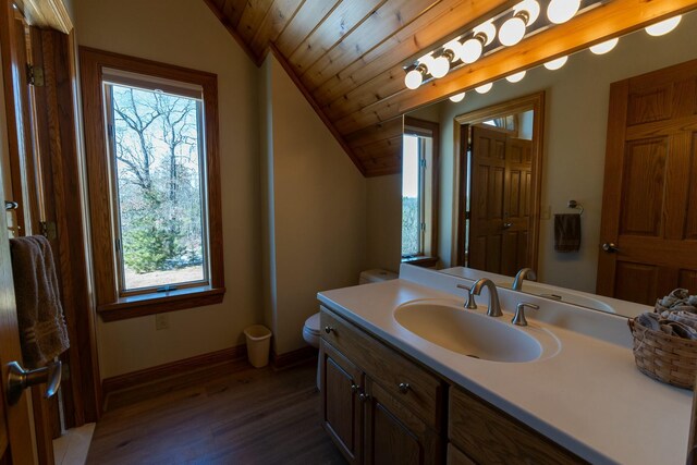 bathroom with baseboards, wood finished floors, vanity, vaulted ceiling, and wood ceiling