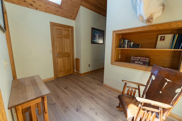 sitting room with baseboards, wood finished floors, vaulted ceiling, and wood ceiling