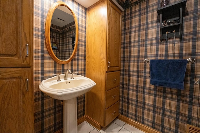 bathroom with baseboards, wallpapered walls, and tile patterned flooring
