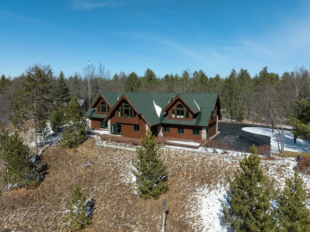 view of front of house featuring a wooded view