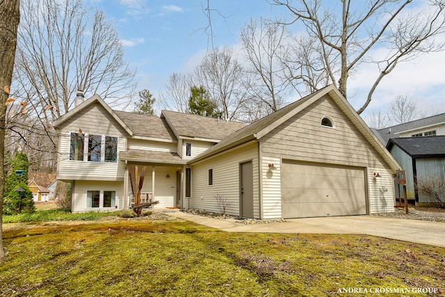 split level home with a balcony, a chimney, a garage, and concrete driveway