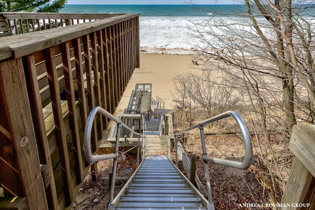 surrounding community featuring a water view and a view of the beach