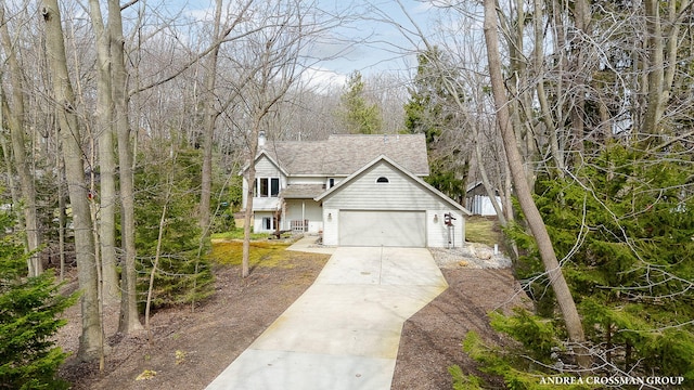 view of front of house featuring roof with shingles and concrete driveway