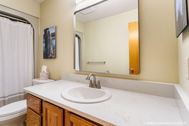 full bathroom with toilet and vanity