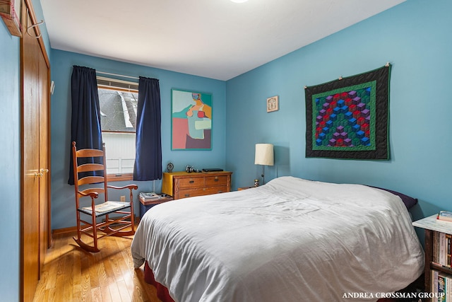 bedroom featuring baseboards and wood finished floors