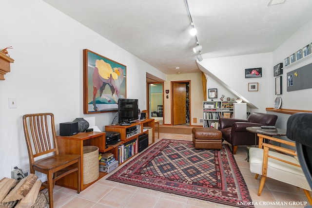 tiled living room with rail lighting and stairway