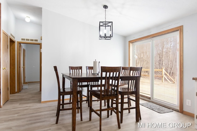 13879 49th St, Grand Junction, MI 49056 - dining space with light wood finished floors, baseboards, visible vents, and lofted ceiling