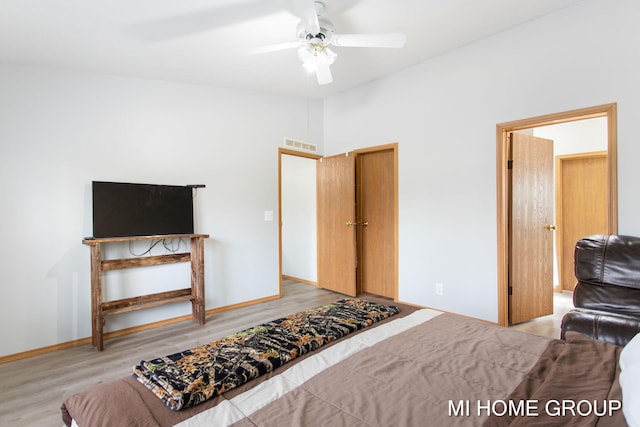 13879 49th St, Grand Junction, MI 49056 - bedroom featuring baseboards, visible vents, vaulted ceiling, and wood finished floors