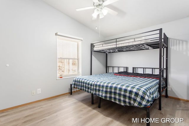 13879 49th St, Grand Junction, MI 49056 - bedroom featuring baseboards, vaulted ceiling, wood finished floors, and ceiling fan