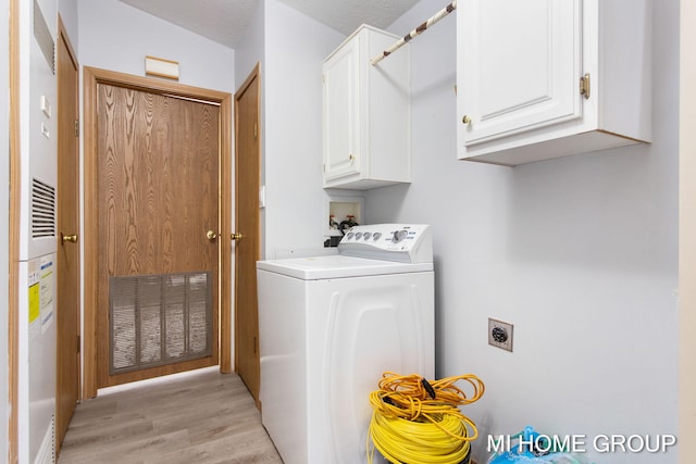 13879 49th St, Grand Junction, MI 49056 - laundry room with light wood-type flooring, cabinet space, visible vents, and washer / dryer