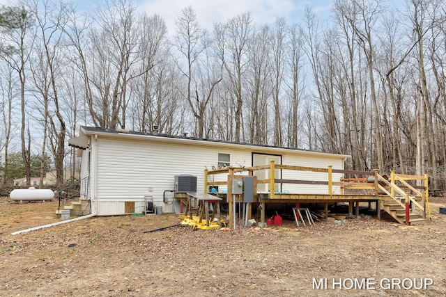 13879 49th St, Grand Junction, MI 49056 - back of property featuring a wooden deck and central AC