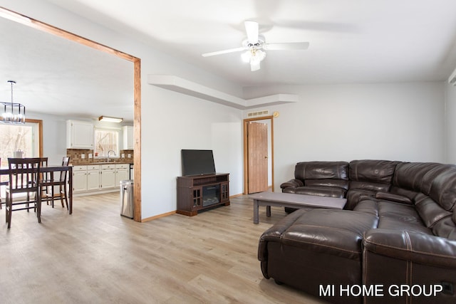 13879 49th St, Grand Junction, MI 49056 - living room featuring baseboards, visible vents, light wood-style floors, and ceiling fan
