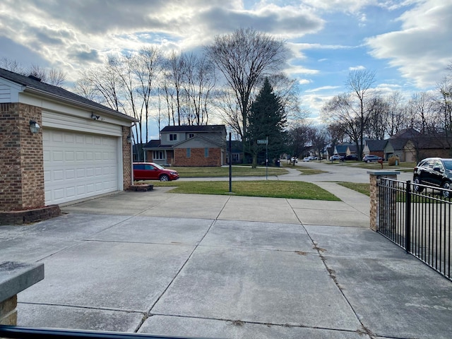 view of road with a residential view and concrete driveway