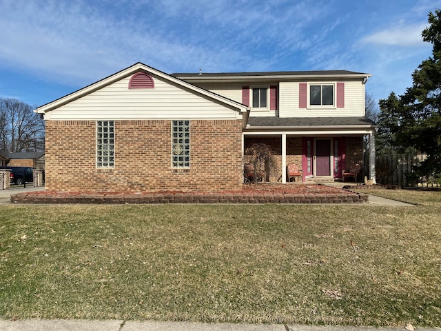 view of front facade featuring brick siding, a porch, and a front yard